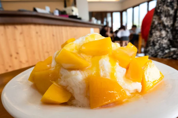 eating mango shaved ice with colorful dessert, famous Taiwanese snacks at Taiwan