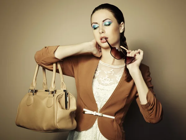 Portrait of beautiful young woman with a leather bag — Stock Photo, Image