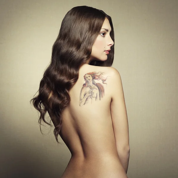 Portrait nude young woman with tattoo — Stock Photo, Image