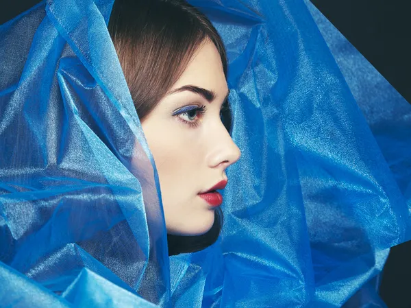 Fashion photo of beautiful women under blue veil — Stock Photo, Image