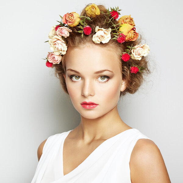 Beautiful woman with flowers. Perfect face skin. Beauty Portrait