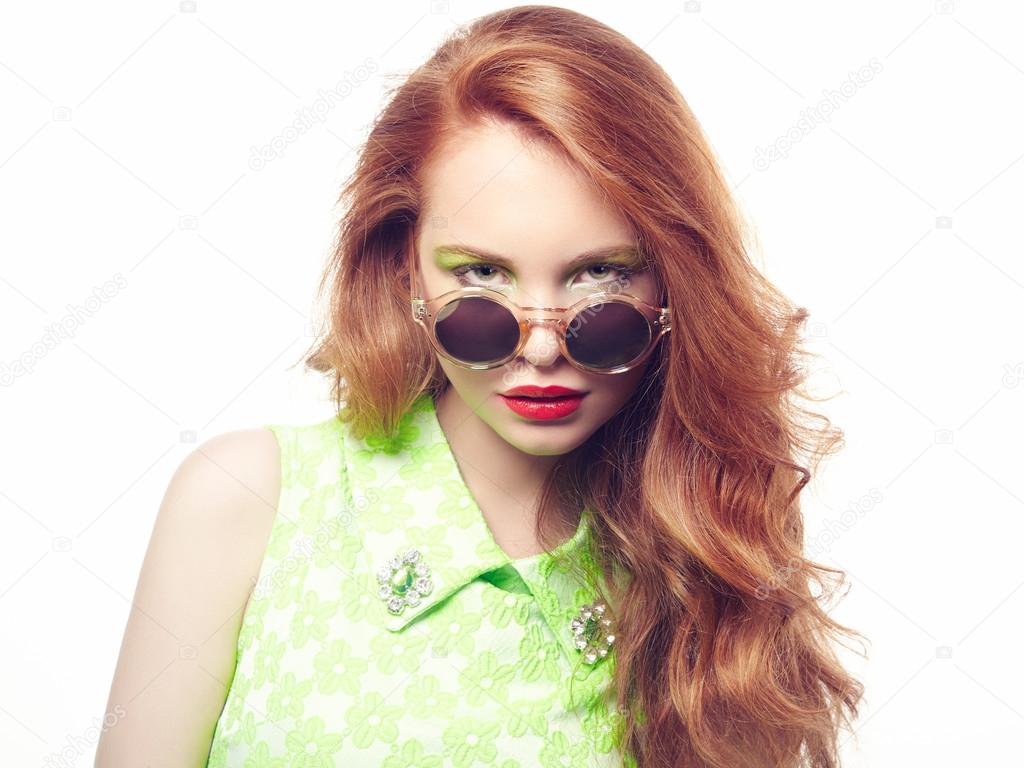 Portrait of beautiful woman in sunglasses on white background
