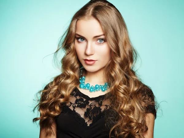 Portrait of beautiful young blonde girl in black dress — Stock Photo, Image