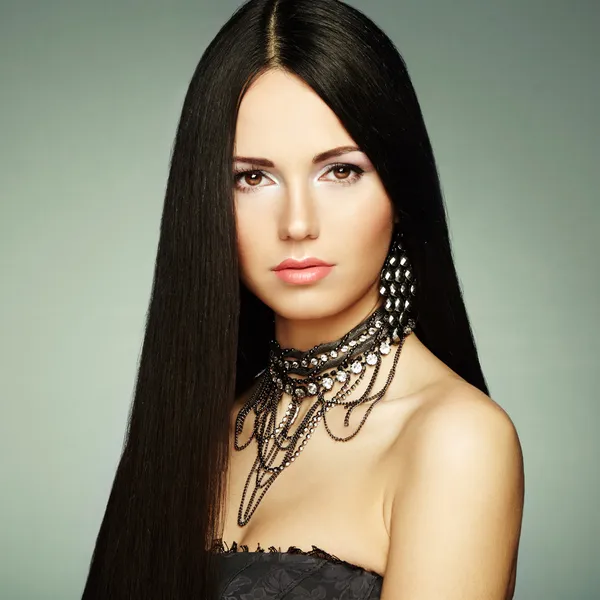 Portrait of young beautiful woman with jewelry — Stock Photo, Image