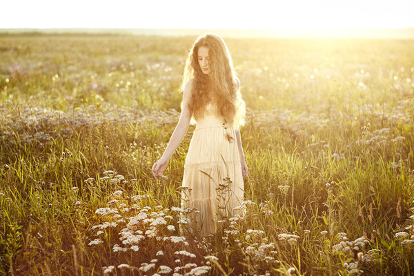 Young beautiful girl on a summer field. Beauty summertime. Fashion photo