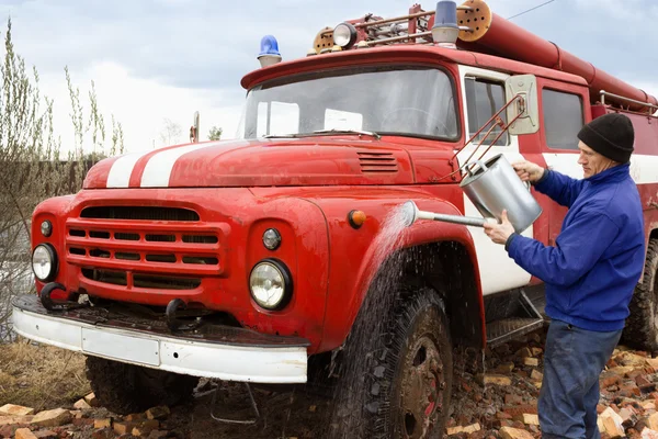 The driver washes the old fire truck — Stock Photo, Image