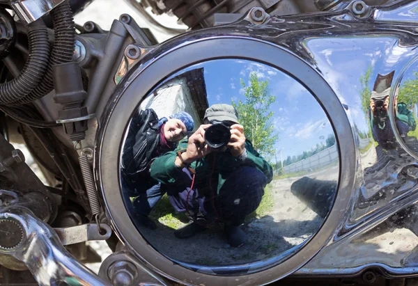Two motorcyclists are reflected in brilliant motor — Stock Photo, Image