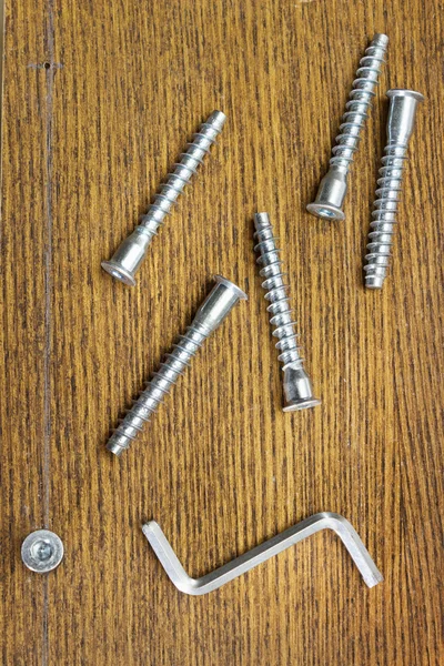 Screws for assembling furniture and simple tool — Stock Photo, Image