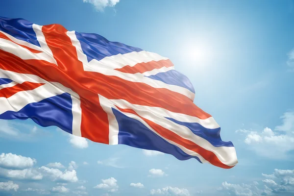 Union jack in the blue sky — Stock Photo, Image