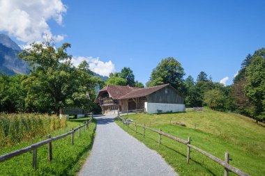 An image of an idyllic farmhouse in the swiss alps