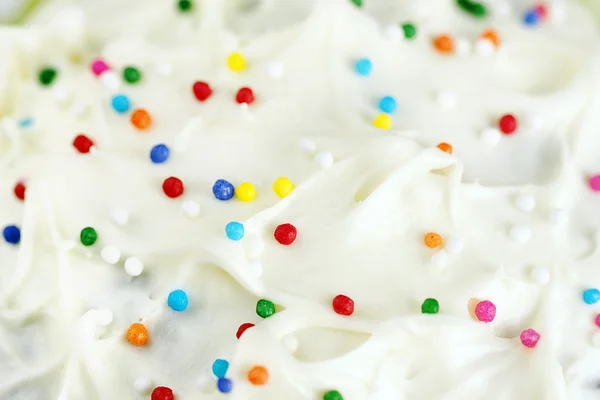 Cream cheese frosting and candy background — Stock Photo, Image