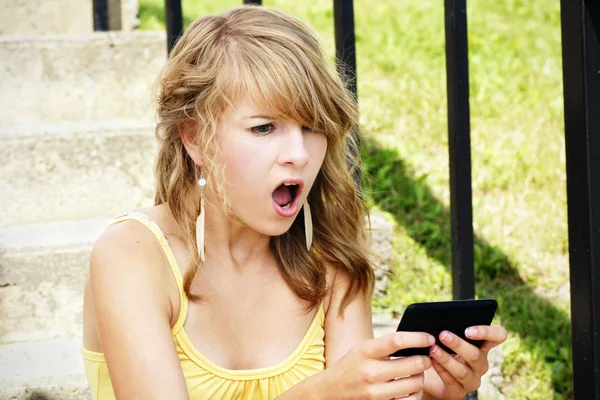 Shocked young blond reading text — Stock Photo, Image