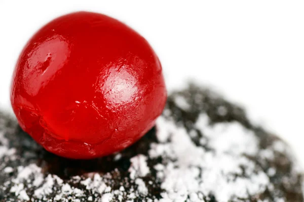 Maraschino cherry on chocolate cake — Stock Photo, Image