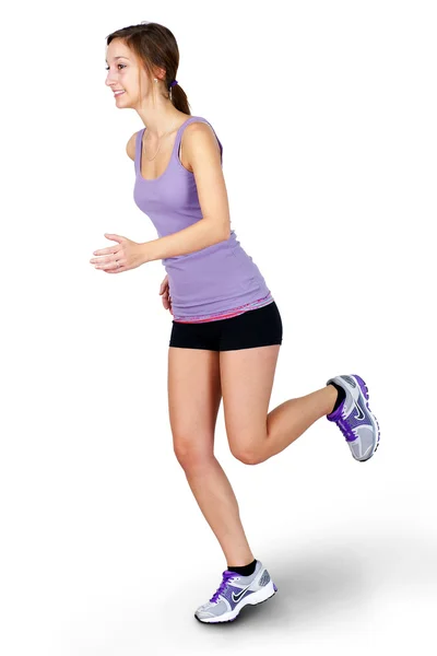 Young woman jogging over white background — Stock Photo, Image