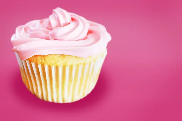 Vanilla cupcake with pink frosting — Stock Photo, Image