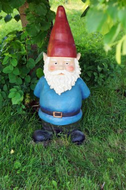 Garden gnome looking at camera clipart