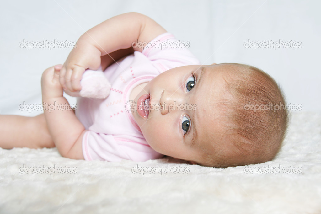 Baby girl holding foot