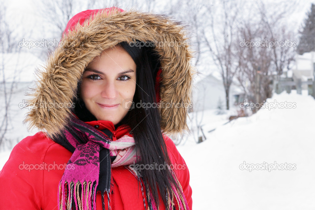 Portrait of young woman with red winter coat