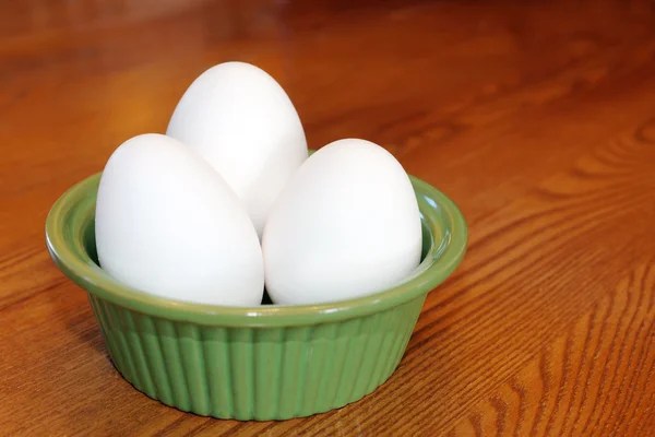 Eggs in a green bowl — Stock Photo, Image
