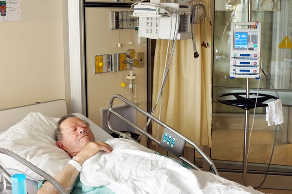 Homme âgé dans un lit d'hôpital — Photo