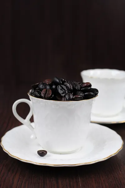Coffee cup filled with coffee beans — Stock Photo, Image
