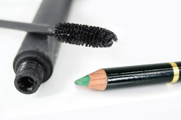 Black mascara and green eye pencil — Stock Photo, Image