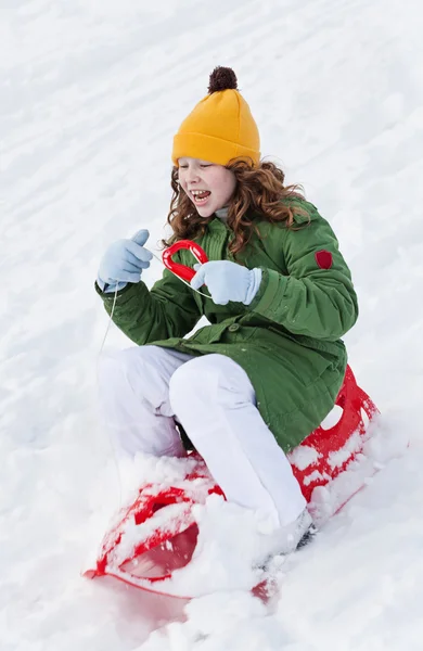 Girl rides sledge down hill — Stock Photo, Image