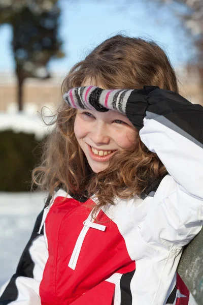 Smiling girl sitting on a bench — Stock Photo, Image