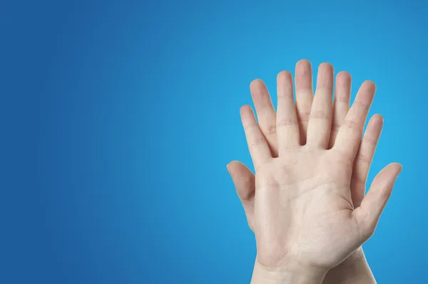 Close-up of human hand on blue background — Stock Photo, Image