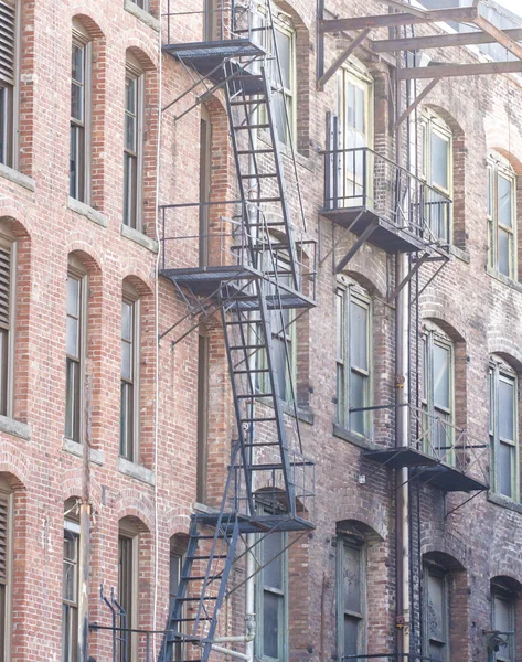 Wrought Iron Fire Escapes in Brick Alley — Stock Photo, Image