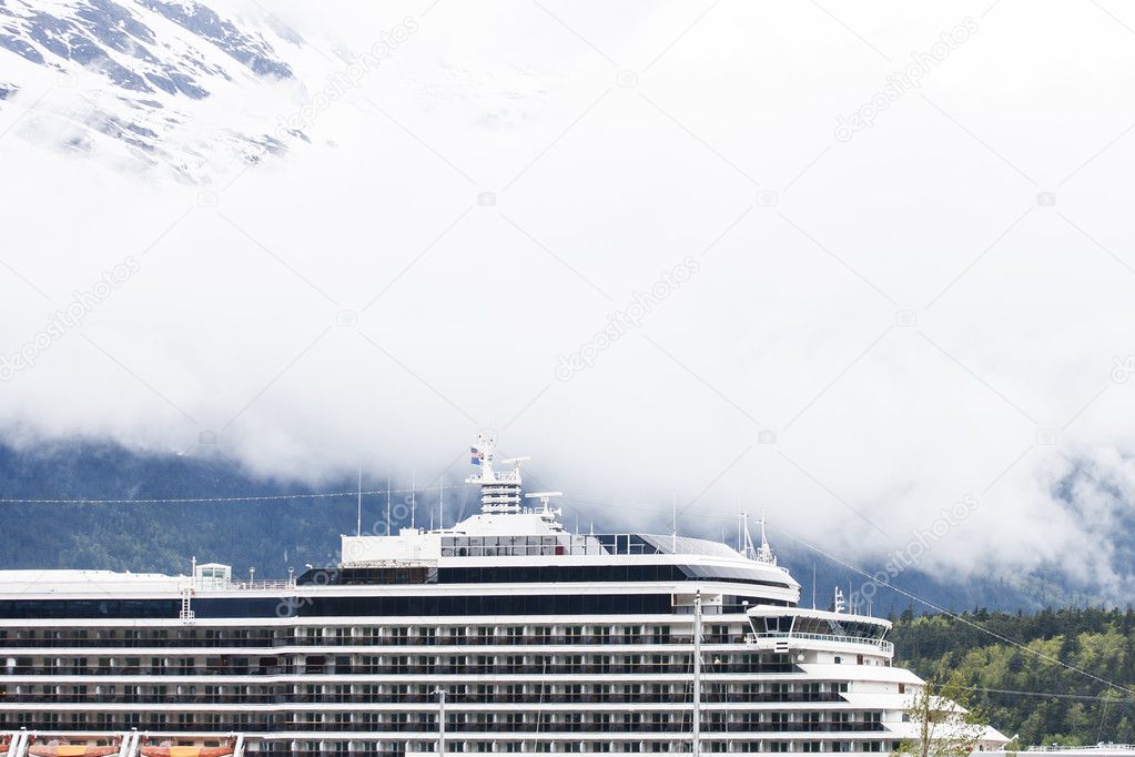 Cruise Ship Under Foggy Mountains