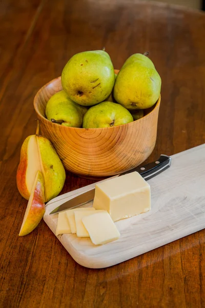 Cuenco de peras con queso en rodajas y una pera cortada — Foto de Stock