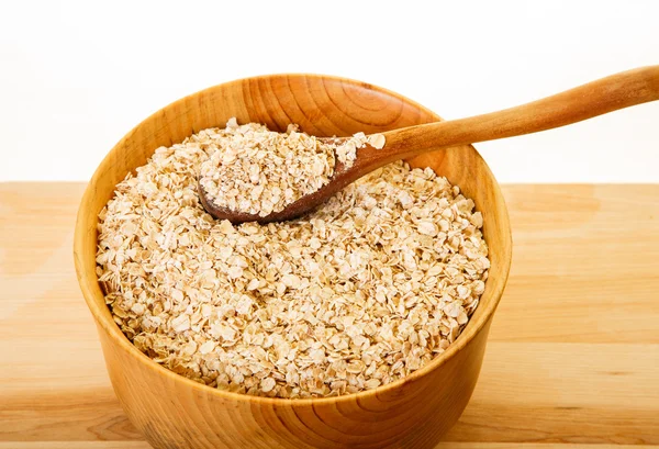 Dry Oatmeal in Bowl with Wood Spoon — Stock Photo, Image