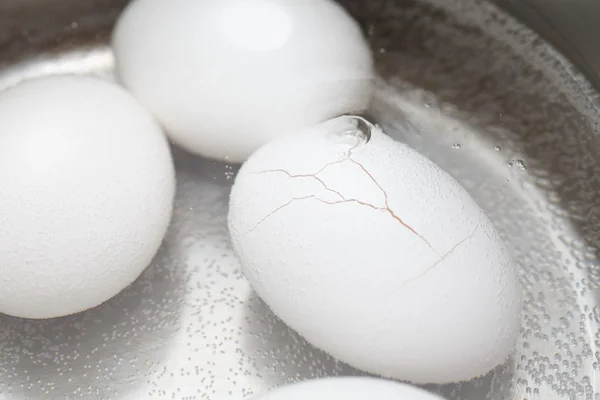 Simmering Eggs with One Cracked — Stock Photo, Image