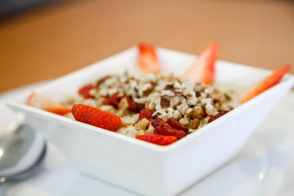 Strawberries and Walnuts in Oatmeal — Stock Photo, Image