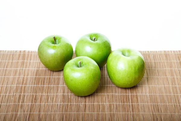 Four Green Apples on Bamboo Mat — Stock Photo, Image