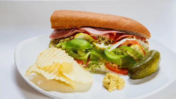 Sub Sandwich with Chips and Pickle — Stock Photo, Image