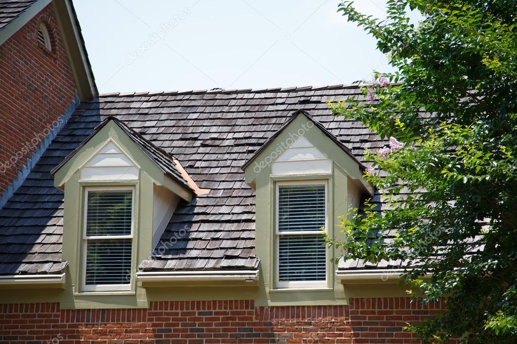 Two Dormers On Brick Homes With Wood Shingles Stock Photo