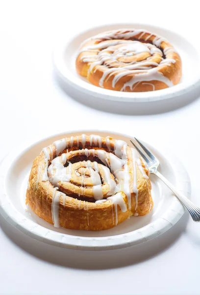 Two Cinnamon Rolls on White Plates — Stock Photo, Image