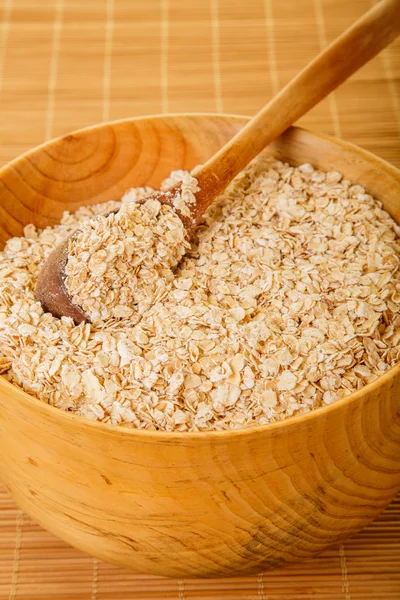 Wood Spoon in Bowl of Oatmeal — Stock Photo, Image