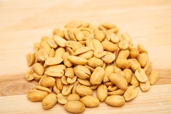 Amendoins salgados na tábua de madeira — Fotografia de Stock