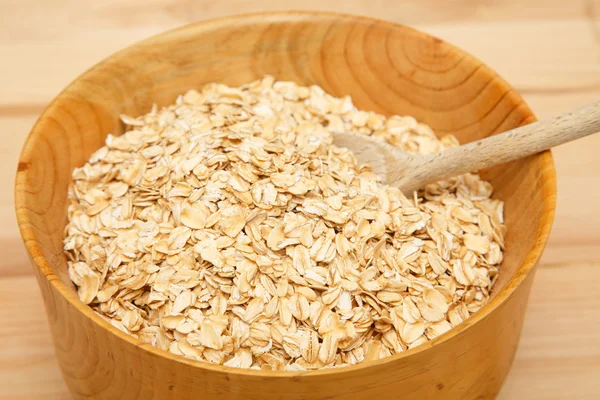 Oats with Wood Spoon in Bowl — Stock Photo, Image