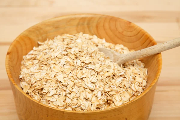 Bowl of Dry Oats with Wood Spoon — Stock Photo, Image