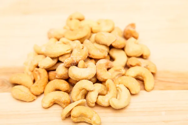 Rostade saltade cashewnötter trä ombord — Stockfoto