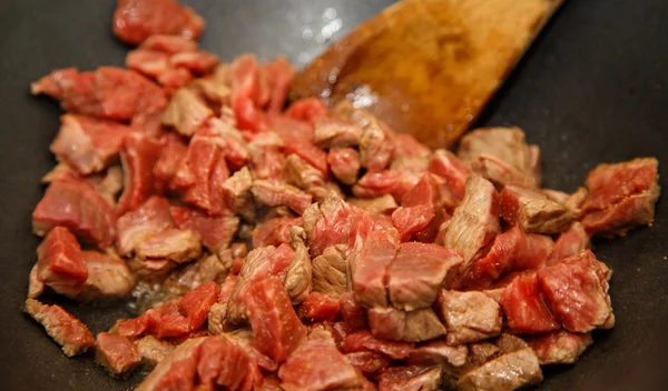 Stirring Beef in Wok with Wood Spoon — Stock Photo, Image