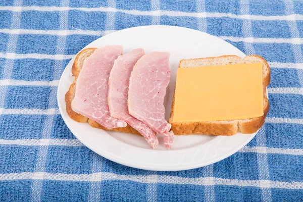 Sandwich abierto de jamón y queso en una toalla azul —  Fotos de Stock