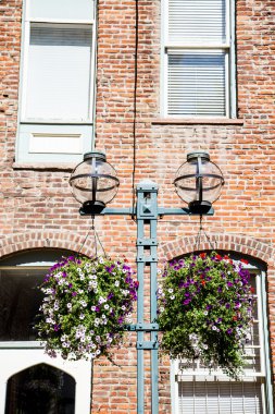 tuğla duvar tarafından eski elektrik direği çiçek sepetleri