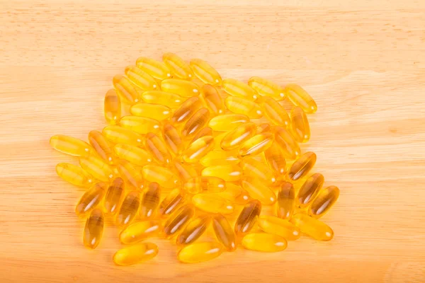 Gel Capsules on Wood Table — Stock Photo, Image