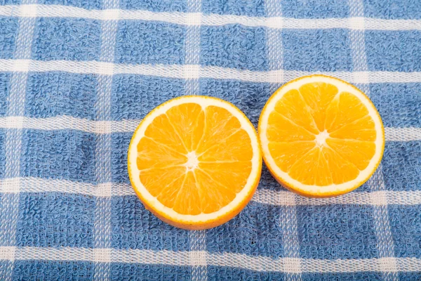Halved Oranges on Blue Towel — Stock Photo, Image