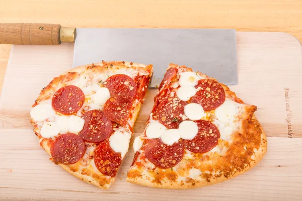 Pepperoni Pizza Cut with Cleaver — Stock Photo, Image
